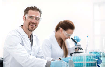 two scientists biologists sitting at the laboratory tableの写真素材