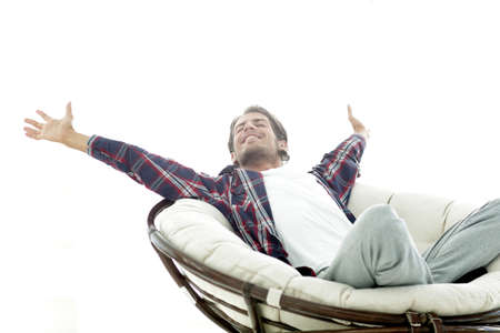 stylish guy stretching in a comfortable chairの写真素材