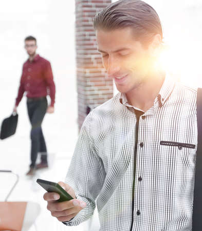 employee reads a text message on smartphoneの写真素材
