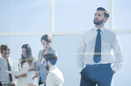 serious businessman standing in the officeの写真素材