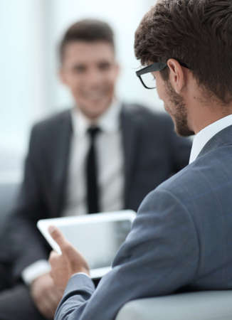 two young businessmen discuss ideas with a tabletの写真素材