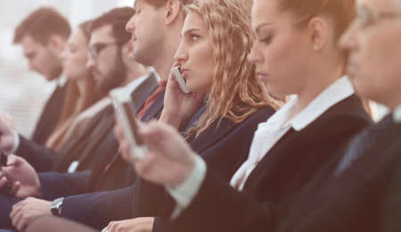 closeup of colleagues sitting at a business conference.の写真素材