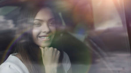 thoughtful business woman sitting in car backseatの写真素材
