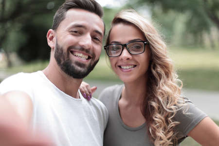 smiling young couple on background of city Parkの写真素材