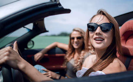 Beautiful woman sitting in cabrioletの写真素材