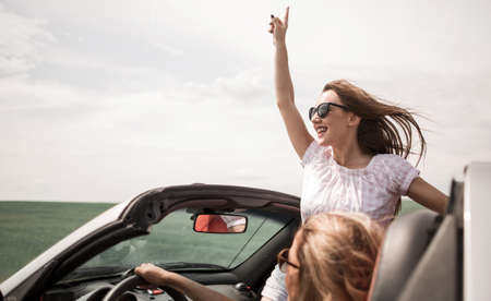 close up. happy young woman traveling in a convertibleの写真素材