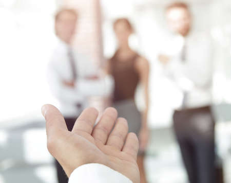 background image of businessman holding out hand for a handshake.の写真素材