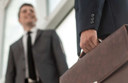 close up.business partners standing near the office windowの写真素材