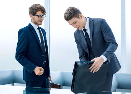 two business people discuss financial documents.の写真素材