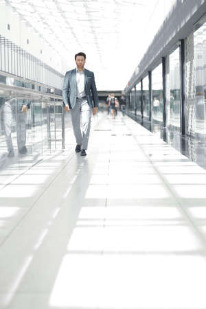 businessman walking in the airport buildingの写真素材