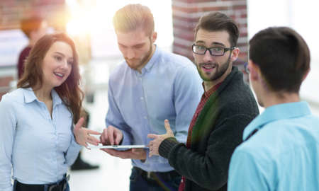 Business team with tablet pc computer having discussion in officの写真素材