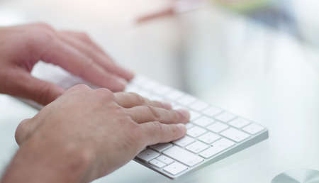 close-up of hand typing text on computer keyboard.