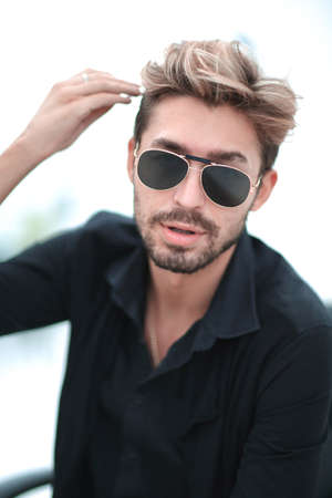 Businessman sitting in park using mobile phoneの写真素材