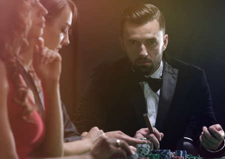 Group of stylish people playing in a casinoの写真素材