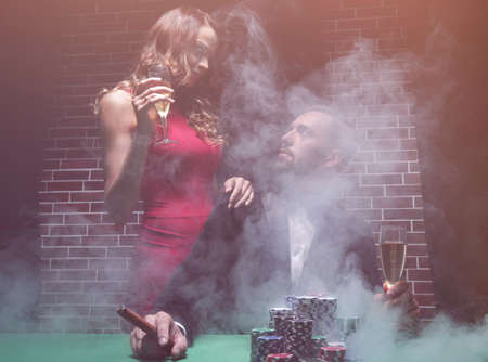 Couple in the casino playing poker on green feltの写真素材