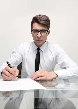 close up.businessman signs a document sitting at the office Deskの写真素材