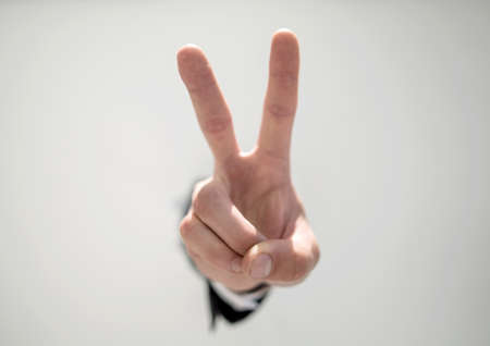 close up. businessman showing a gesture of victory.の写真素材