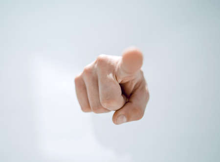 close up.a mans hand breaking through the paper and pointing soの写真素材