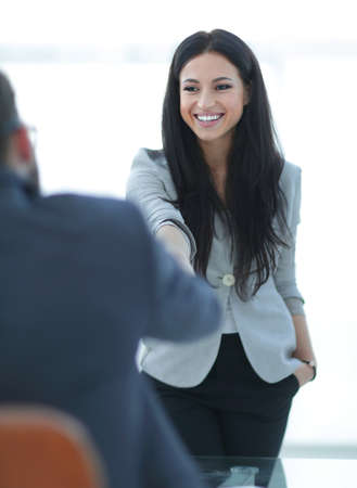 business woman welcomes colleague with handshakeの写真素材