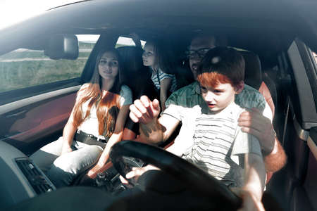 Young father with his little son driving car togetherの写真素材