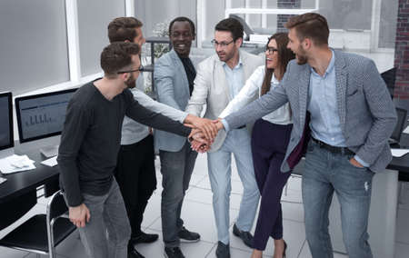 friendly business team putting their hands together
