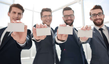 blank business cards in the hands of the business teamの写真素材