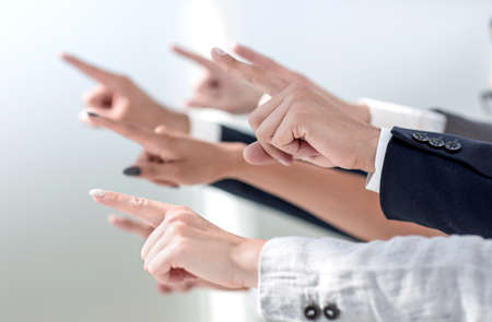 side view. the hands of business team pointing at a copy space.の写真素材