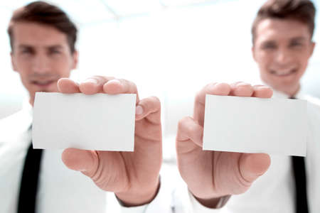 close up.business colleagues showing their business cards.の写真素材