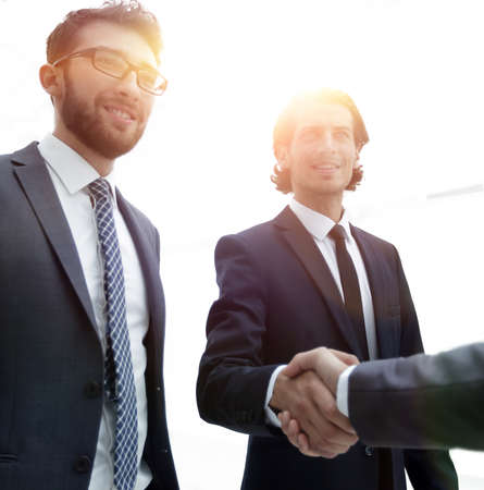 business group welcomes partner with a handshake
