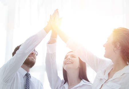 successful business team giving each other a high five.の写真素材