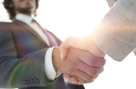 Excited smiling businessman handshaking partner at meeting,の写真素材