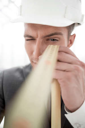 engineer with a construction roulette at the person