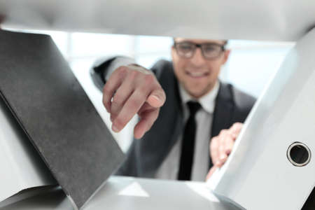 businessman is pointing his finger at the camera
