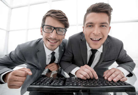 businessmen are looking directly into the camera while sitting iの写真素材