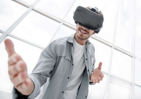 Enjoying new reality. Attractive young man in VR headset gesturiの写真素材