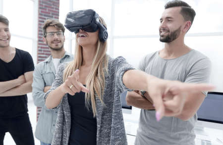 woman standing in the office with VR glasses