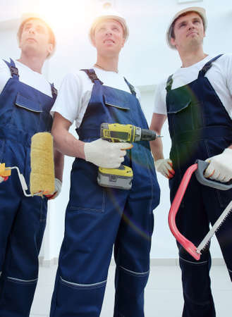 team of construction workers with working tools