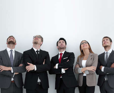 Happy positive business group looking up with dreaming expressionの写真素材