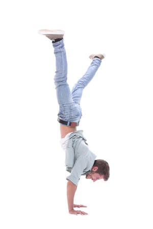 in full growth. happy young man standing on his hands