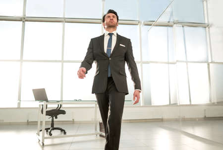 modern businessman standing in a bright officeの写真素材