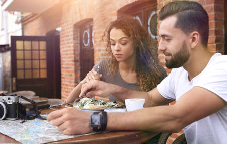 Portrait of lovely romantic couple sitting in a cafe with coffeeの写真素材