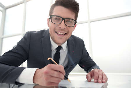 close up.young businessman signing a document