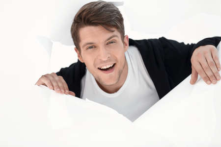 young businessman breaking through a paper wall.の写真素材