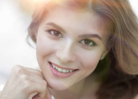 closeup portrait of a smiling young woman with light make-upの写真素材