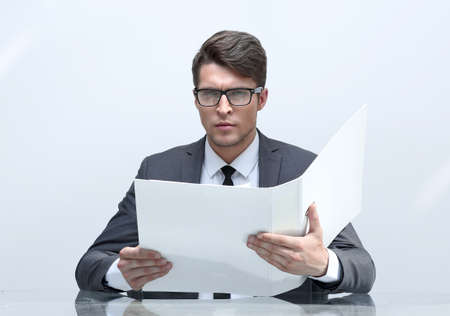 close up. businessman reading documents sitting at his Deskの写真素材