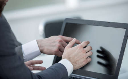 close up.businessman using laptop in the workplace