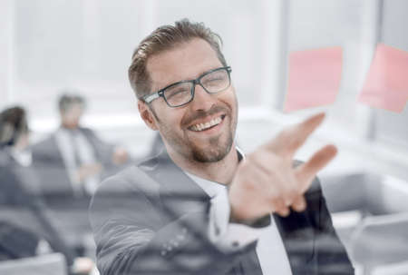 close up.a successful employee of a sticky note on glass