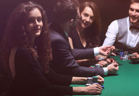 players sitting at the playing table in the casinoの写真素材
