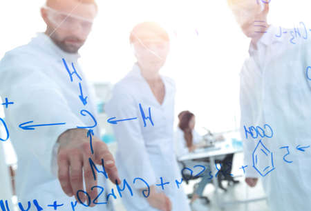 group of laboratory scientists discussing their research in the laboratory.の写真素材