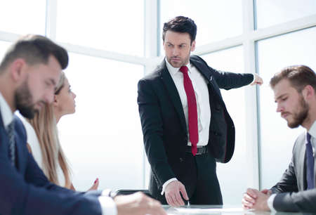 angry businessman holds a working meeting with the business team